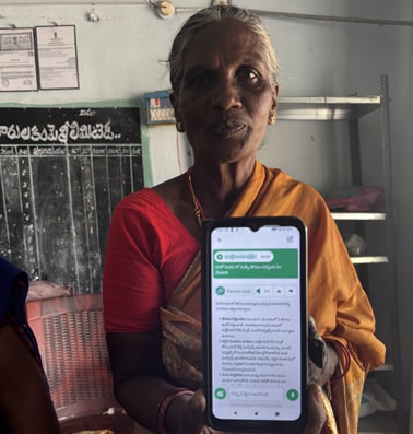 Padmavati, a farmer from Nagireddypalem, shows the FarmerChat application on her phone. 