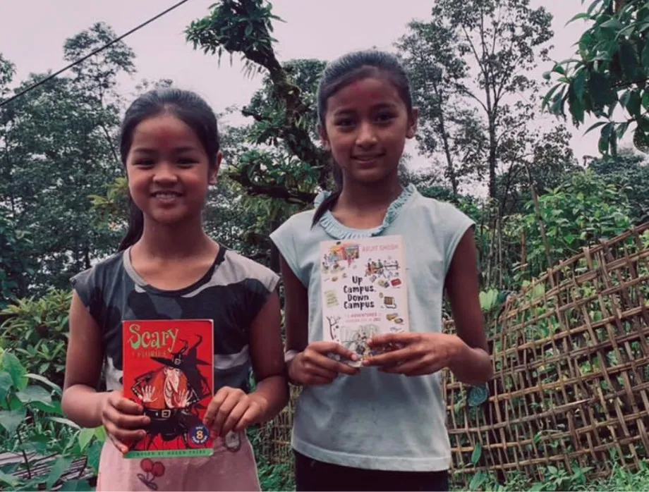 Two girls holding books second